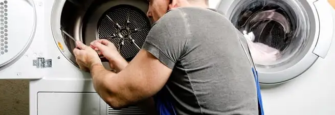 Dryer repair technician fixing a clothes dryer drum in Birmingham, AL