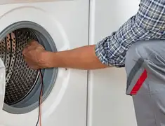 Dryer repair technician diagnosing and servicing a clothes dryer in Birmingham, AL