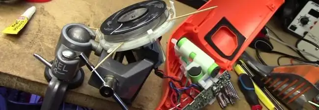 Vacuum cleaner repair parts and tools on a workbench in Birmingham, AL