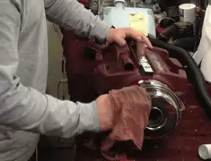 Vacuum repair technician cleaning and servicing a vacuum motor in Birmingham, AL